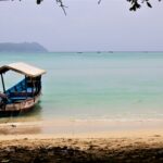 Bharatpur Beach’s vibrant coral reefs and turquoise waters under a serene Andaman sky