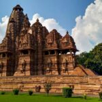 Khajuraho’s Kandariya Mahadeva Temple with intricate carvings under a golden Madhya Pradesh sky