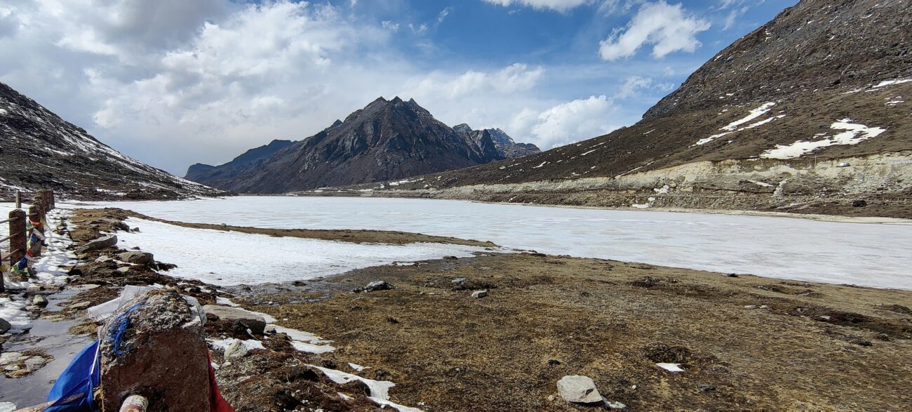 Sela Pass’s snow-clad peaks and serene Sela Lake under a vibrant Himalayan sky in Arunachal Pradesh