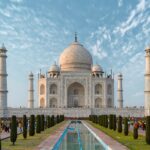 Taj Mahal’s white marble dome and minarets reflecting on the Yamuna River in Agra